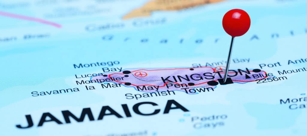 Photo of pinned Kingston on a map of North America.